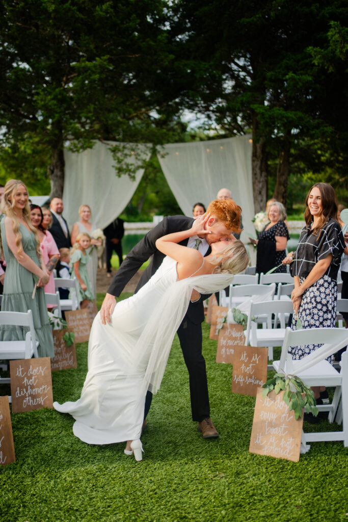 Couple having their first kiss during wedding