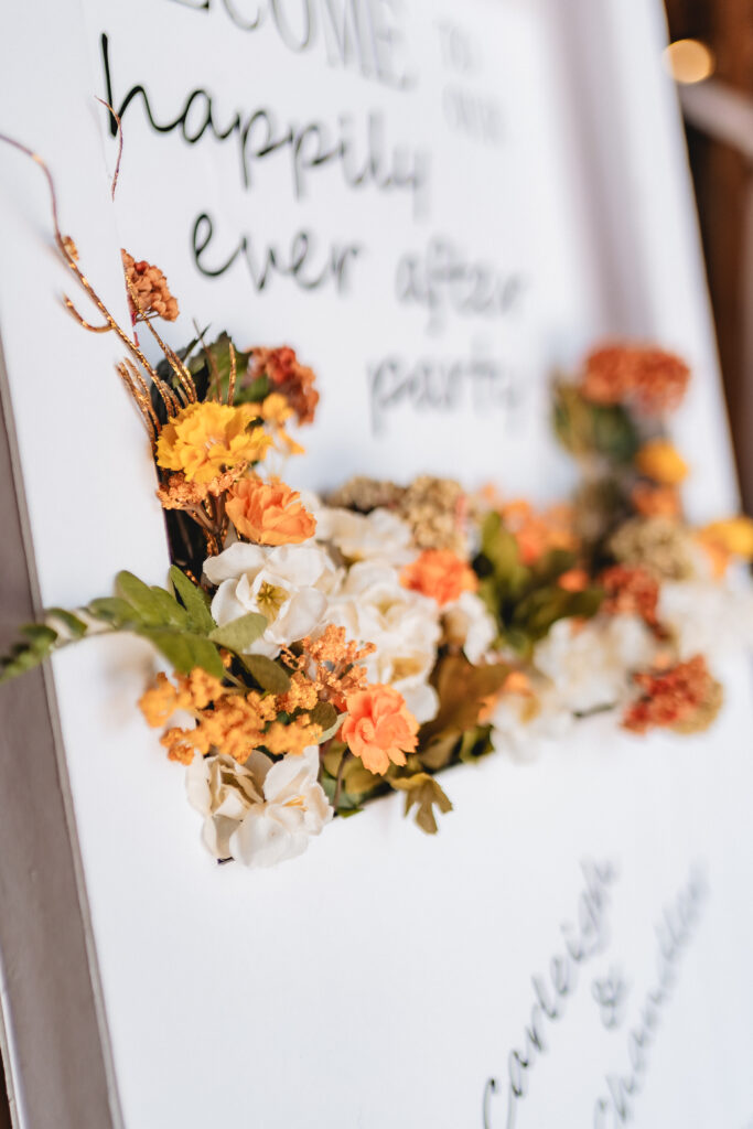 Orange flowers in a wedding sign