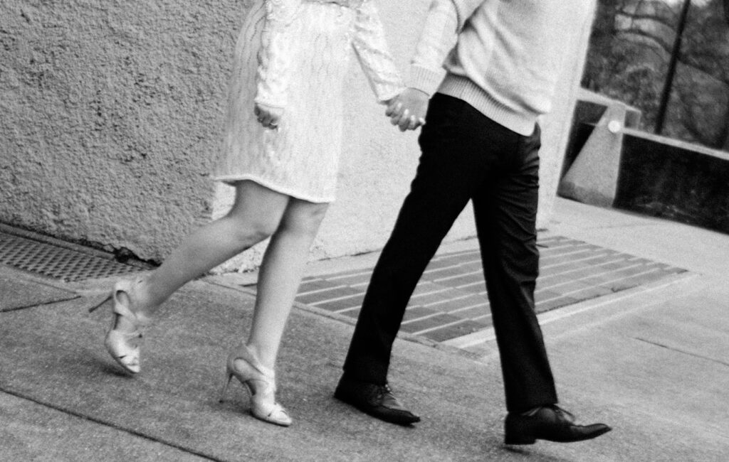 Couple walking holding hands at world fair pavilion