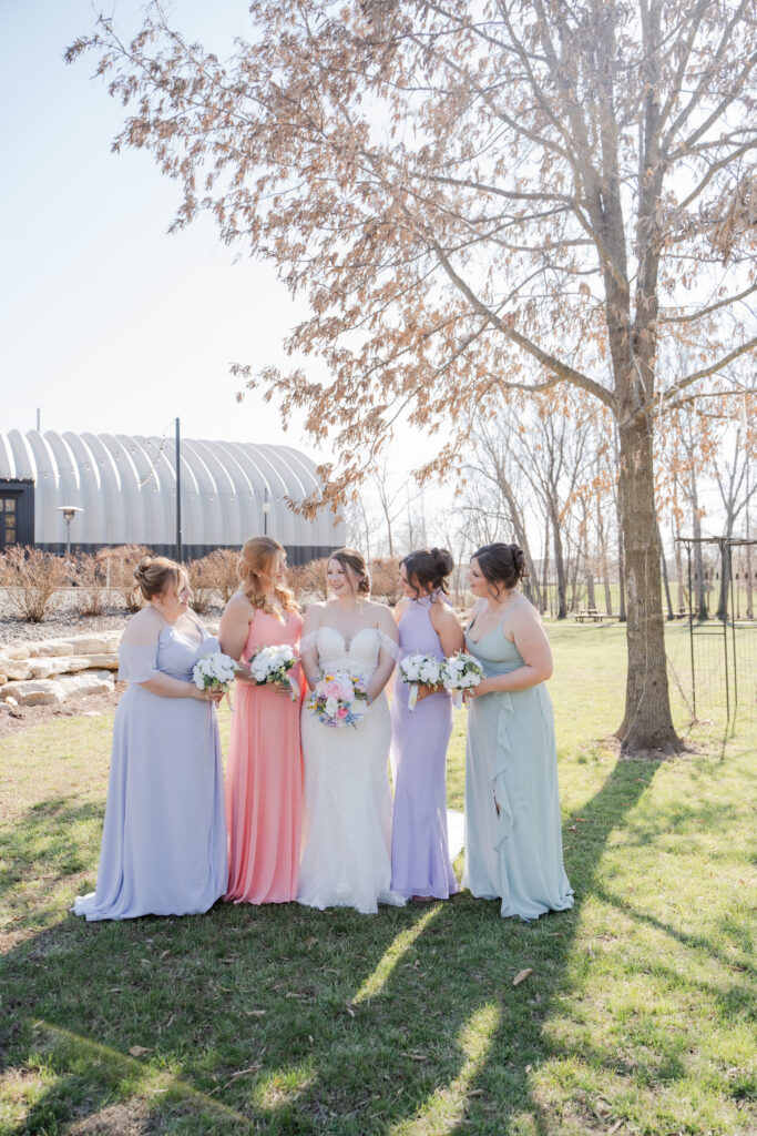 bridesmaids and bride wearing pastel dress- pastel bridesmaids dresses